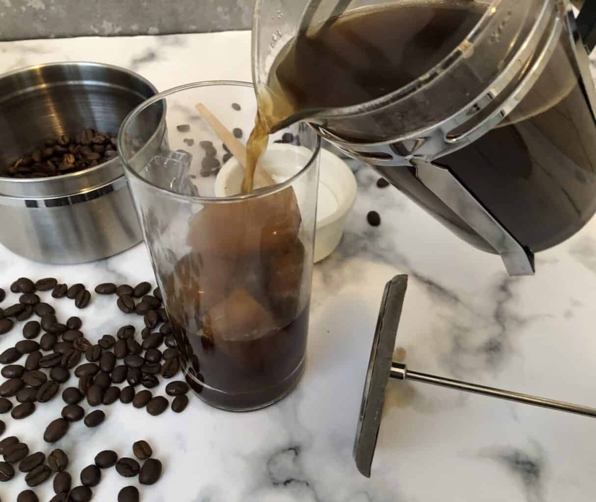 French press coffee poured over coffee ice