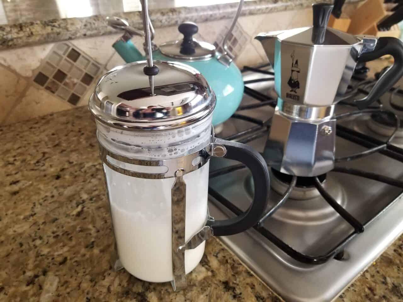 Frothing milk with a French press