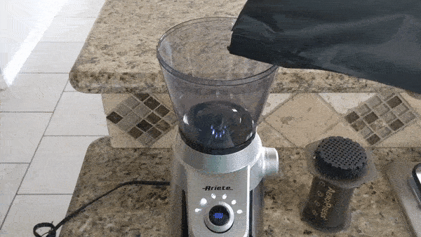 Putting coffee in grinder