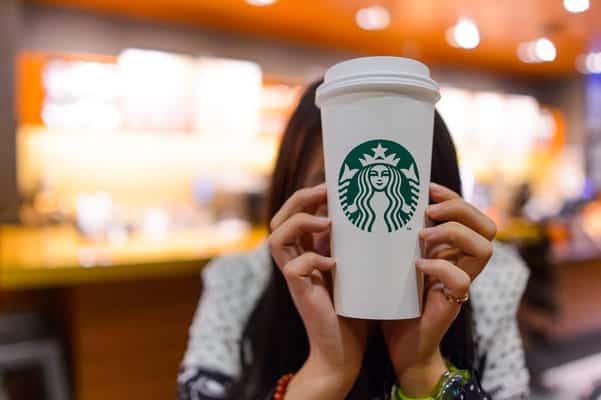 Girl holding starbucks cup